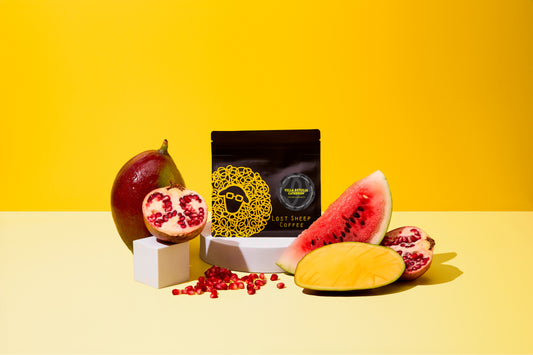 Lost Sheep Coffee's Caturron in black packaging surrounded by Mango, Watermelon and Pomegranate 