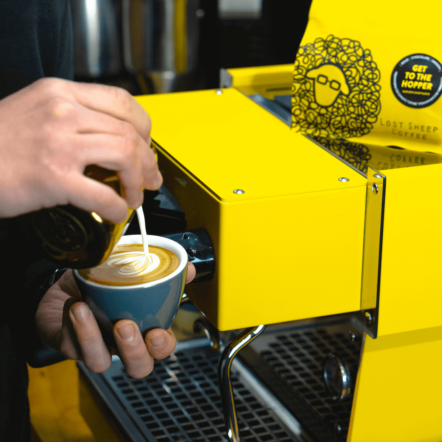 Making flat white coffee using Lost Sheep Coffee on yellow espresso machine